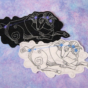 May include: Two embroidered patches featuring the Aries constellation. One patch is black with white stitching, and the other is white with black stitching. Both patches depict a ram with a constellation of stars.