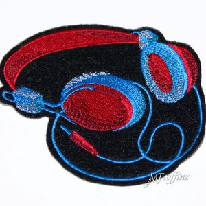 May include: Embroidered patch of red and blue headphones on a black background. The patch is designed to look like a pair of headphones with a red headband and blue earcups.