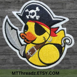 May include: A yellow rubber duck wearing a black pirate hat with a skull and crossbones design, a red bandana, and an eyepatch. The duck is holding a silver sword and has a hook for a hand.