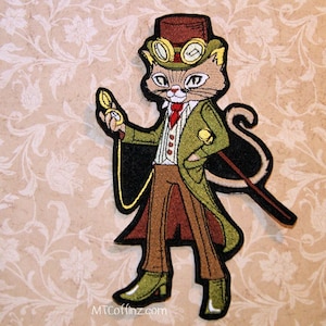 May include: Embroidered iron-on patch of a cat wearing a top hat, goggles, and a vest. The cat is holding a pocket watch and a cane. The patch is on a beige background with a floral pattern.