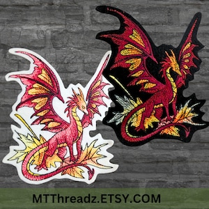 May include: Two embroidered iron-on patches of a red dragon with yellow wings perched on a bed of yellow and orange leaves. The dragon on the left is on a white background and the dragon on the right is on a black background.