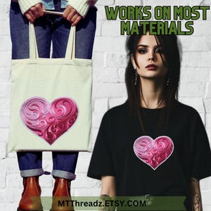 May include: A pink and white heart with a swirling design is embroidered on a white tote bag and a black t-shirt. The text "WORKS ON MOST MATERIALS" is displayed above the image. The text "MTTthreadz.ETSY.COM" is displayed below the image.