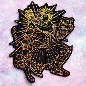 May include: Gold embroidered patch of a figure holding a lyre and a bow and arrow. The figure is wearing a tunic and has a crown on their head. The patch is on a black background.