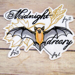May include: Embroidered patch featuring a bat with outstretched wings, in shades of gray and orange, set against a white background. The words "Midnight dreary" are written in a script font. Gold leaf accents and fig. 1, fig. 2, and fig. 3 are also included.