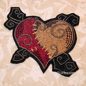 May include: A black felt heart-shaped patch with a red and brown stitched heart in the center. The heart is stitched together with a thick black thread. The patch has a black felt border with a decorative design.