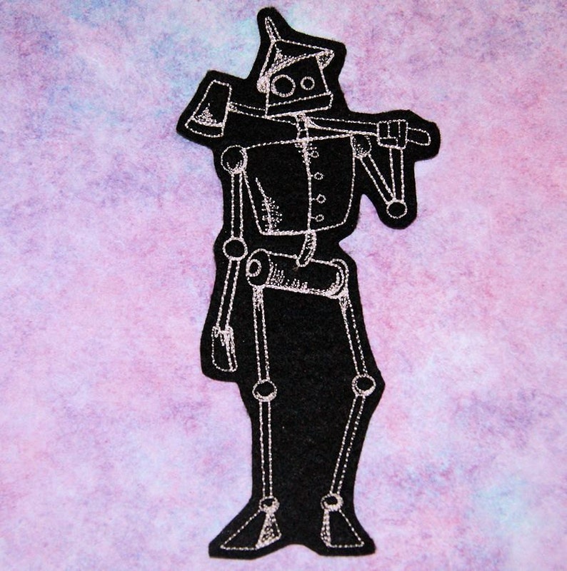 May include: A white outline of a robot with an axe on its shoulder, embroidered on a black felt patch.