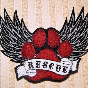 May include: Red paw print with black wings and a white banner that says "RESCUE".