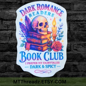 May include: A die-cut sticker featuring a human skull resting on a stack of three books, a lit candle, a rose, and purple feathers. The text reads: DARK ROMANCE READERS BOOK CLUB, I PREFER MY FAIRYTALES DARK & SPICY, with a decorative flourish.