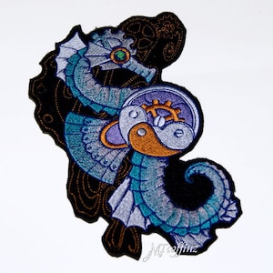 May include: An embroidered iron-on patch featuring a blue and silver seahorse with a steampunk-style clock face. The patch is on a black background with gold accents.