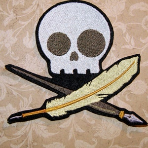 May include: Embroidered patch featuring a white skull and crossbones with a quill pen. The skull has black eyes and a black mouth. The quill pen is gold and has a black nib.