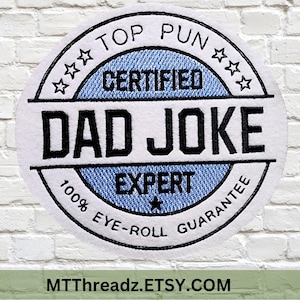 May include: A white embroidered patch with the text "TOP PUN CERTIFIED DAD JOKE EXPERT" in black. The patch has a blue denim-like background and a guarantee of 100% eye-roll. The Etsy shop name is at the bottom.