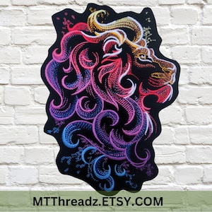 May include: Embroidered patch of a lion's head with a colorful, swirling design in shades of pink, blue, and yellow. The lion's mane is made up of intricate swirls and the background is black.