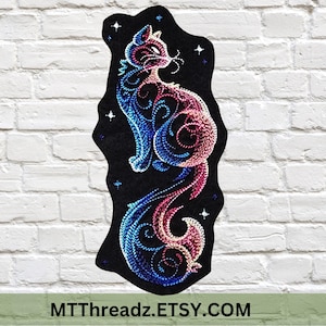 May include: A black embroidered cat design with blue and pink swirls and star accents. The cat is sitting with its tail curled. The text "MTThreadz.ETSY.COM" is at the bottom.
