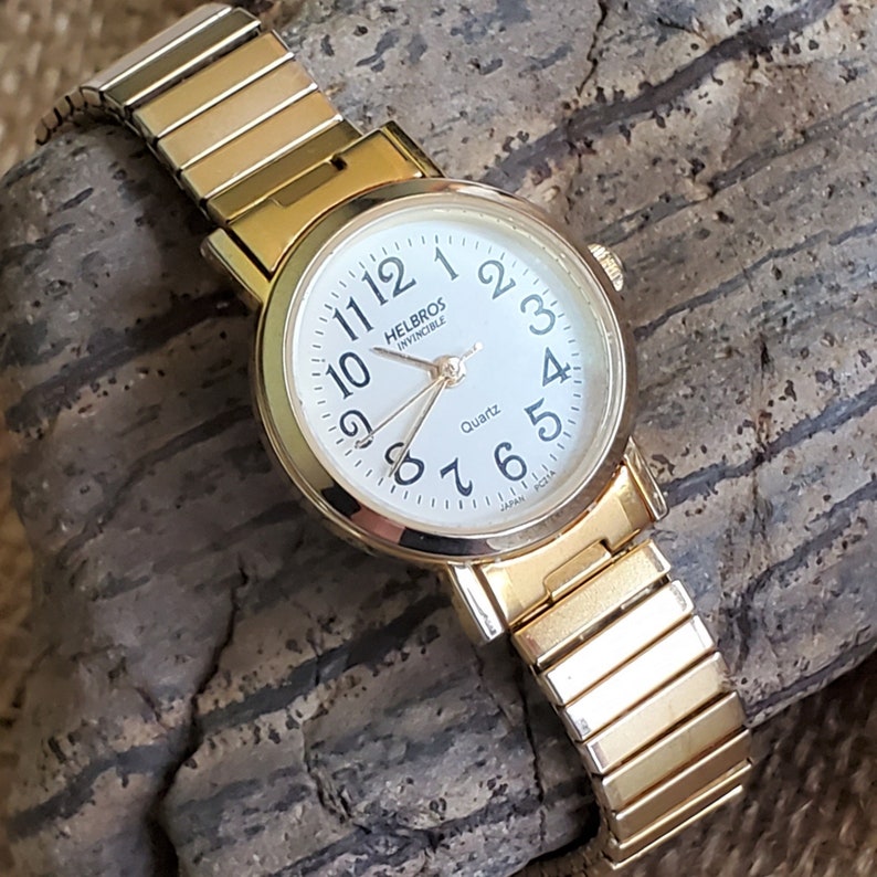 elite ladies gold tone watch
