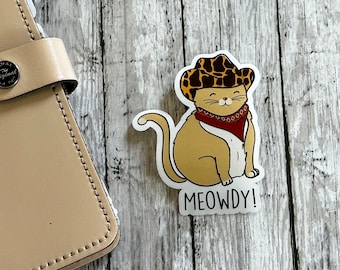 Meowdy kattklistermärke, cowboykattklistermärke, vinyllaptopklistermärke, kattälskarepresent, vinylkattklistermärke, genomskinligt klistermärke, present till kattälskare, kattmeme