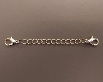 May include: Silver chain extender with two lobster claw clasps.