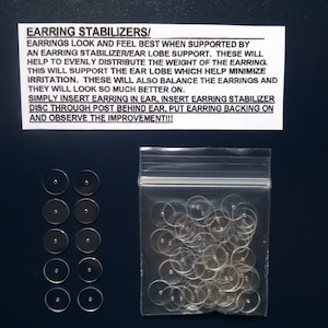 May include: A clear plastic bag filled with small, clear plastic earring stabilizers. The bag is labeled "Earring Stabilizers/ Earrings look and feel best when supported by an earring stabilizer/ear lobe support. These will help to evenly distribute the weight of the earring. This will support the ear lobe which help minimize irritation. These will also balance the earrings and they will look so much better on. Simply insert earring in ear, insert earring stabilizer disc through post behind ear, put earring backing on and observe the improvement!!!"