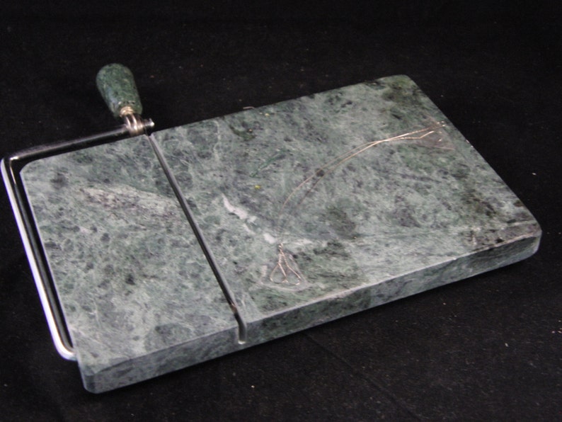 May include: Green marble cheese board with a built-in wire cheese slicer and a green marble handle.