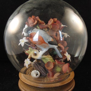 Vintage Victorian style decorating flowers and porcelain bird dome with wooden base