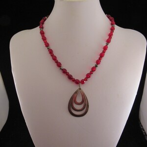 Red necklace beads with silver pendant