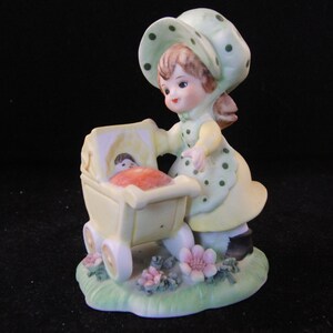 Vintage figurine girl with doll