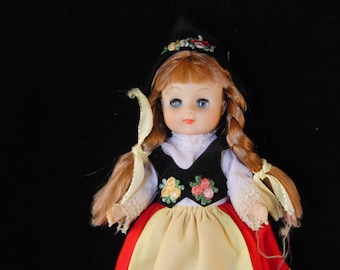 Vintage doll in red dress
