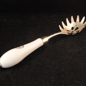 Metal serving spoon by &quot;Silversmith&quot;