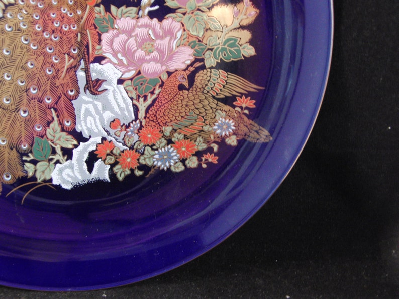 Vintage blue plate with peacock