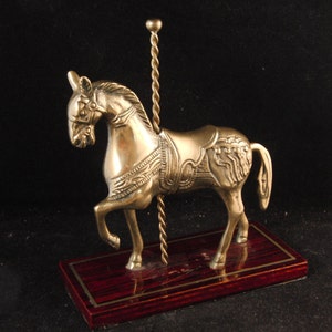 Vintage metal horse on the wooden base