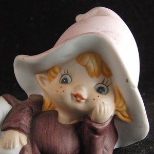 Porcelain figurine of boy in a hat.