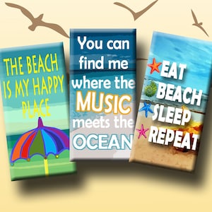 May include: Three colorful domino-sized magnets with beach-themed designs. The first magnet says "The beach is my happy place" and features a beach umbrella. The second magnet says "You can find me where the music meets the ocean". The third magnet says "Eat beach sleep repeat" and features a starfish and seashell.