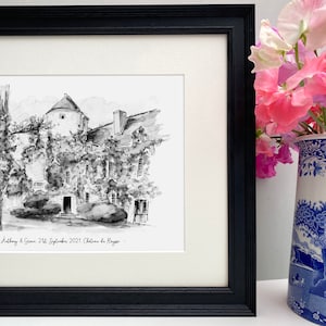 May include: Black and white ink drawing of a French chateau with a tower, surrounded by trees and greenery. The drawing is framed in a black frame and includes the text "Anthony & Grace 21st September 2021 Chateau de Rouge."