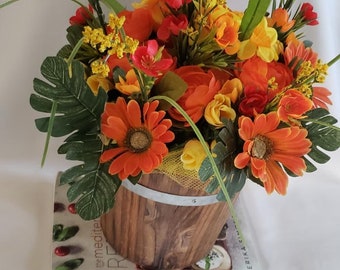 Artificial Flowers in a Wood Bucket. floral Arrangement, Spring Arrangement