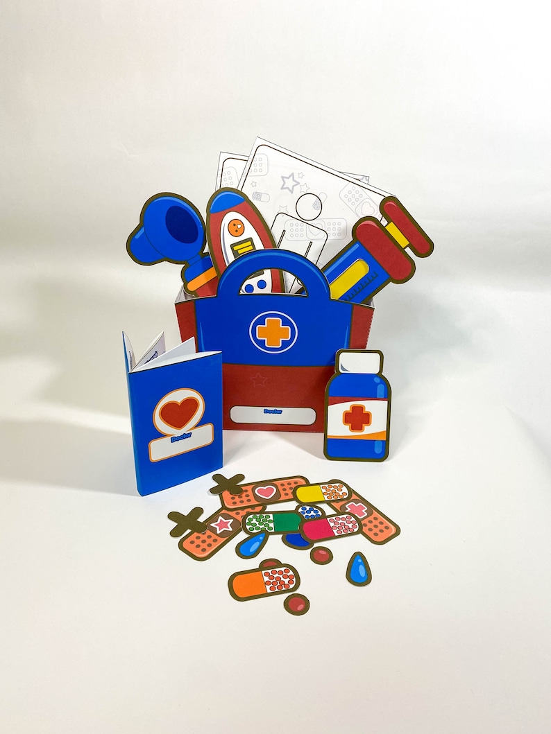 May include: A blue and red first aid kit with a white cross on the front. The kit is open and contains a variety of medical supplies, including bandages, pills, and a thermometer. There are also some coloring pages and a passport.