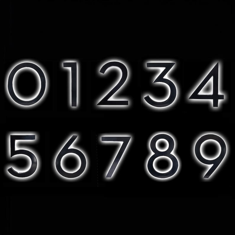 May include: Black numbers 0 through 9 with a white outline against a black background.