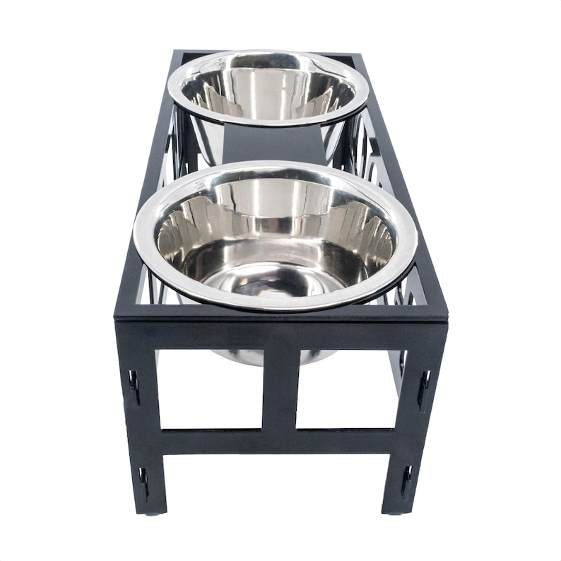 May include: Black metal elevated dog bowl stand with two stainless steel bowls.