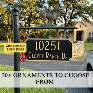 May include: Black address sign with gold lettering displaying the address "10251 Clover Ranch Dr." A deer statue is mounted above the sign. The sign is attached to a black post. Text reads "Address on both sides" and "30+ ornaments to choose from."