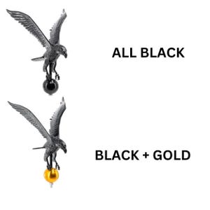 May include: Two eagle finials with wings spread wide. The top eagle is all black, perched on a black sphere. The bottom eagle is black, perched on a gold sphere. Text labels read ALL BLACK and BLACK + GOLD next to the respective eagle figures.