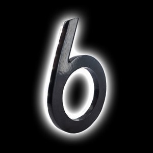 May include: A black metal number six with a glossy finish. The number is illuminated by a white light.