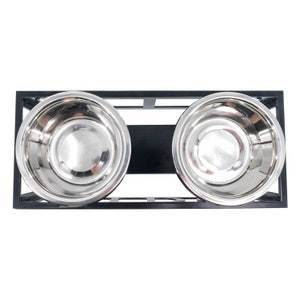 May include: Black metal elevated pet food and water bowl stand with two stainless steel bowls.