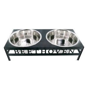 May include: Black metal double dog bowl stand with the word "Beethoven" cut out in the front. The stand has two stainless steel bowls.