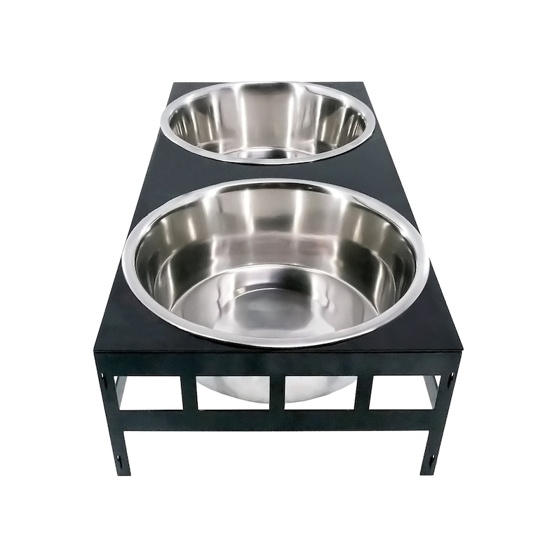 May include: Black metal elevated dog bowl stand with two stainless steel bowls.