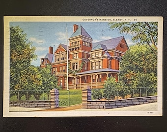 May include: Vintage postcard featuring the Governor's Mansion in Albany, N.Y. The image shows a large, red brick building with multiple stories, a tower, and a green lawn. The postcard has the text "GOVERNOR'S MANSION, ALBANY, N.Y. 36" printed at the top.