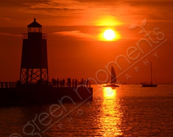 Vertical photograph of Charlevoix light channel and sailboat at sunset