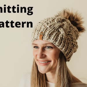 May include: Knitting pattern for a beige cable knit beanie with a faux fur pom pom. The beanie has a leather tag with the text "OLPR" on it.