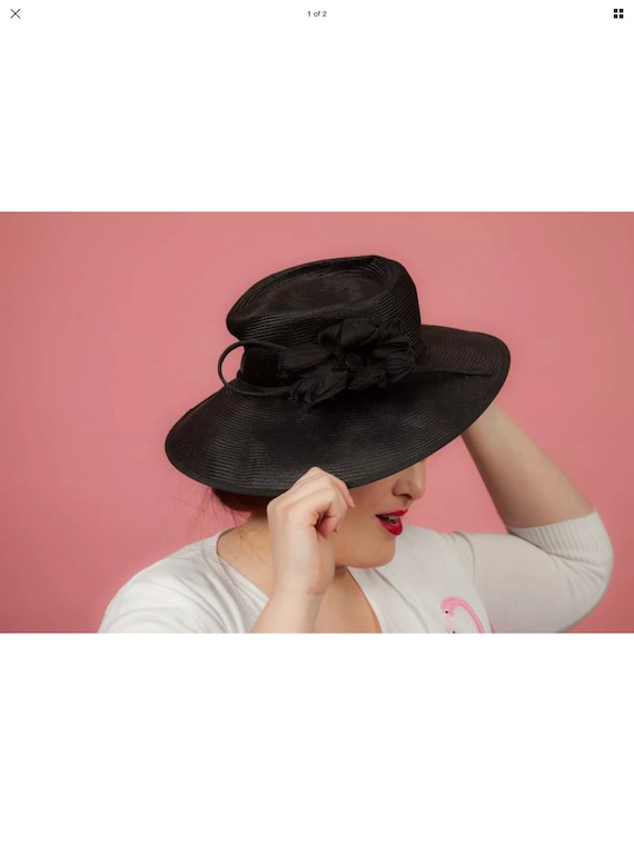 Black formal hat with a flower by Whiteley