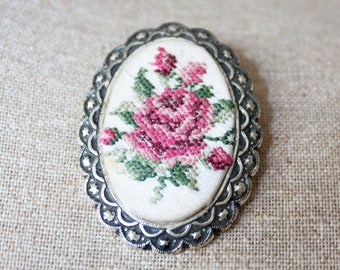 Vintage Floral Cross Stitch Brooch with Elaborate Details Around the Frame.