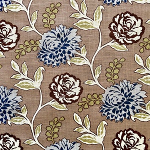 May include: A beige fabric with a floral pattern. The flowers are in shades of brown, blue, and white. The pattern is repeated throughout the fabric.
