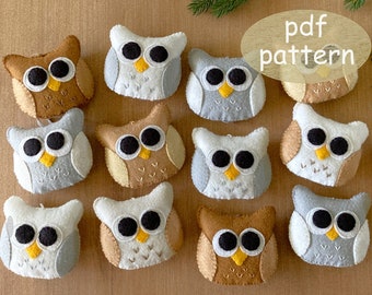 May include: A set of 10 felt owl ornaments in various colors, including brown, beige, gray, and white. The owls have black eyes, yellow beaks, and white felt accents. The owls are arranged in a circle on a wooden surface. The text "pdf pattern" is written in a yellow circle on the top right of the image.