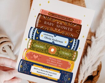 May include: A baby shower invitation with a stack of colorful books, featuring a floral design and the text "JOIN US FOR A BABY SHOWER celebrating Olivia Anderson June 20th 12-2pm Willow Cafe 123 Main Street Pittsburgh, PA RSVP to Marie 812.345.3223 Registered at Target"